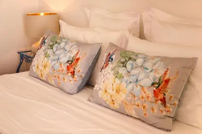 two pillows sitting on top of a bed at Sunshine Villa with Heated Pool in Faro