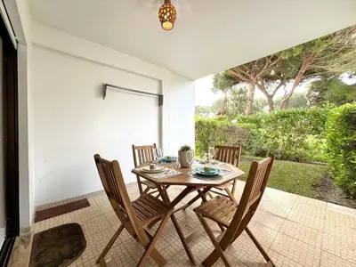a dining room with a table and chairs at Albufeira Cosy by Homing in Albufeira