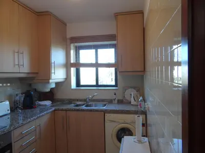 a kitchen with a washing machine and a sink at Porto Marina @Vilamoura in Vilamoura