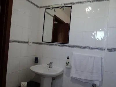 a white bathroom with a sink and a mirror at Porto Marina @Vilamoura in Vilamoura