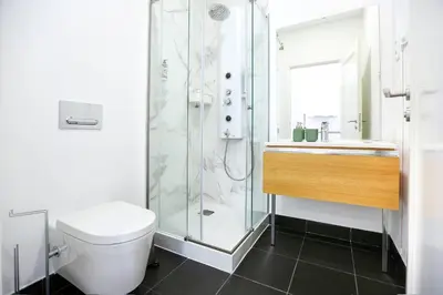 a bathroom with a shower and a toilet and a sink at Ice Cream Call Apartments in Faro