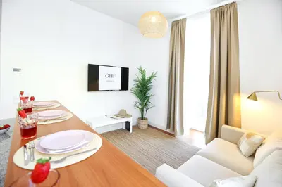 a living room with a table and a couch at Ice Cream Call Apartments in Faro