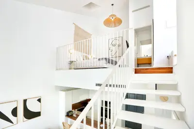 a white staircase in a white house at Vacation Time Apartment in Faro