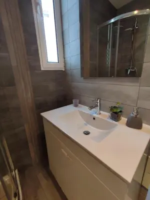 a bathroom with a sink and a mirror at Casa Docim, casa tipica algarvia no centro da cidade velha in Albufeira