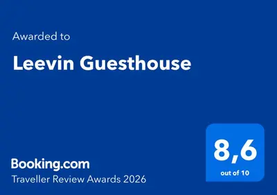a bedroom with a large bed and a balcony at Leevin Guesthouse in Faro