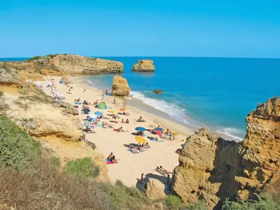 a group of people on a beach near the ocean at Apartment Happy Moments by Interhome in Albufeira