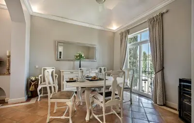 a dining room with a table and chairs and a window at Quinta do Lago 2-Bed Apartment - Golf Pool & Ac in Faro