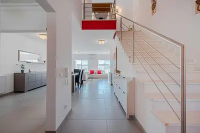 a white hallway with a staircase in a house at V3 Olhos dÁgua com piscina AC wifi 800m praia in Olhos de Água