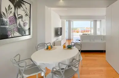 a white dining room with a white table and chairs at Penthouse Triplex com Jacuzzi T3 HsR Vilamarina in Vilamoura