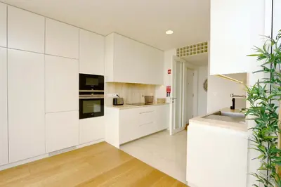 a white kitchen with white cabinets and a sink at La Vila Nature, Laguna Village 246-Clever Details, Luxury apartment, located in a quiet area, BBQ and free Wi-Fi in Vilamoura