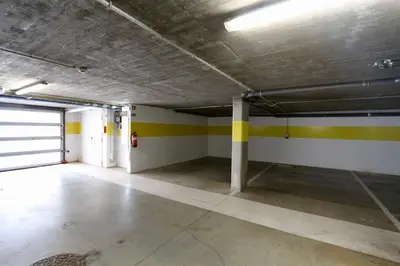 an empty garage with yellow and white stripes on the walls at La Vila Nature, Laguna Village 246-Clever Details, Luxury apartment, located in a quiet area, BBQ and free Wi-Fi in Vilamoura