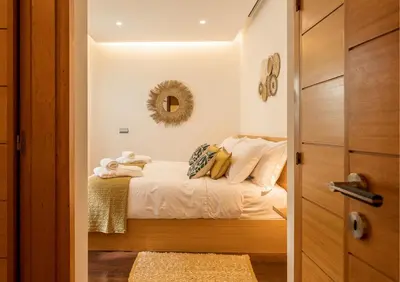 a bedroom with a bed and a mirror on the wall at Algarve: Vale Lobo Golf&Beach with Private Pool II in Almancil
