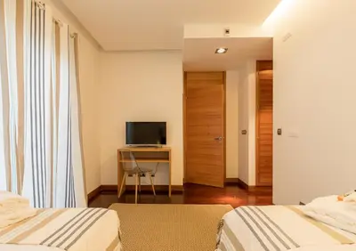 a bedroom with two beds and a desk with a television at Algarve: Vale Lobo Golf&Beach with Private Pool II in Almancil