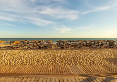 a beach with umbrellas and chairs and the ocean at Algarve: Vale Lobo Golf&Beach with Private Pool II in Almancil