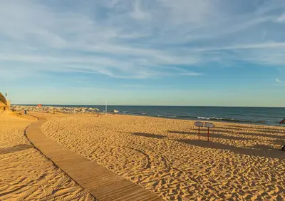 a sandy beach with a sign in the middle at Algarve: Vale Lobo Golf&Beach with Private Pool II in Almancil