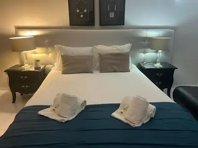 a bedroom with a large white bed with pillows at Casa da Praia - Santa Eulália Beach in Albufeira