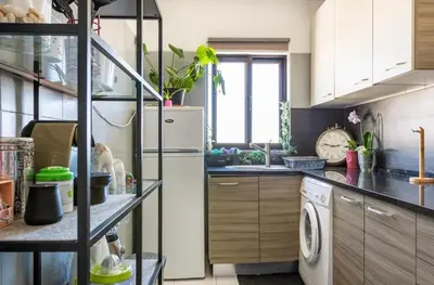 a kitchen with a refrigerator and a sink at Casa da Praia - Santa Eulália Beach in Albufeira