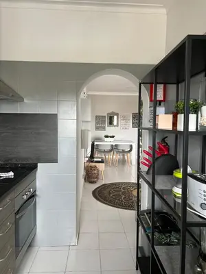 a kitchen with an archway leading to a dining room at Casa da Praia - Santa Eulália Beach in Albufeira