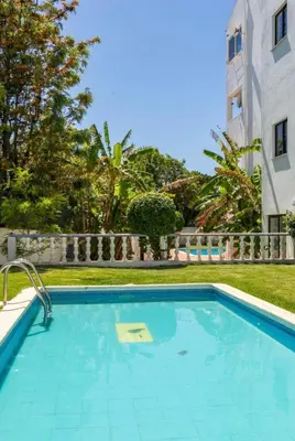 a swimming pool in front of a building at Casa da Praia - Santa Eulália Beach in Albufeira