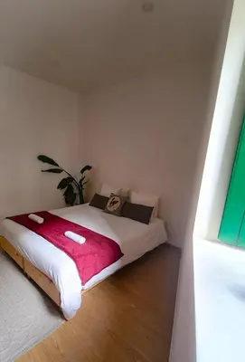 a bedroom with a large bed with a pink blanket at Mezzanine 4 Faro in Faro