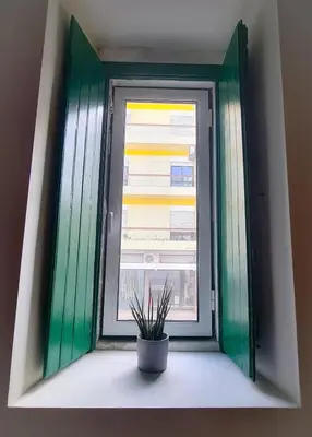 a window with a potted plant sitting on a window sill at Mezzanine 4 Faro in Faro