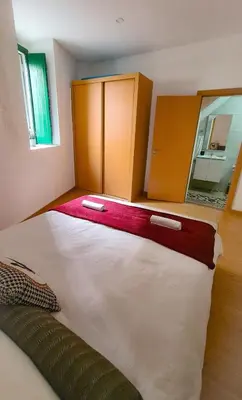 a large white bed in a room with a mirror at Mezzanine 4 Faro in Faro