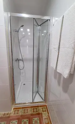 a shower with a glass door in a bathroom at Mezzanine 4 Faro in Faro