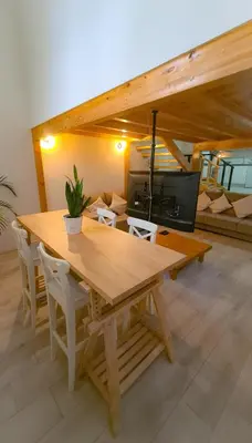 a wooden table and chairs in a living room at Mezzanine 4 Faro in Faro