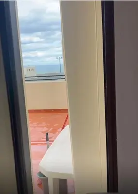 a room with a table and a view of a balcony at Albufeira Home in Albufeira