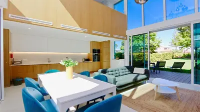 a living room with a white table and blue chairs at Villa Miya - Clever Details, walking distance from the Marina, restaurants, bakeries and supermarkets,, free wifi, pool in Vilamoura
