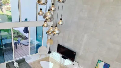 a living room with a fireplace and a chandelier at Villa Miya - Clever Details, walking distance from the Marina, restaurants, bakeries and supermarkets,, free wifi, pool in Vilamoura
