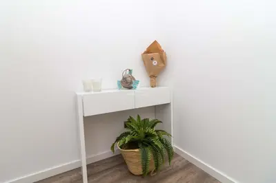 a white console table with a plant on it at Apartment Terracos do Mar - By Dalma Portuguesa in Quarteira