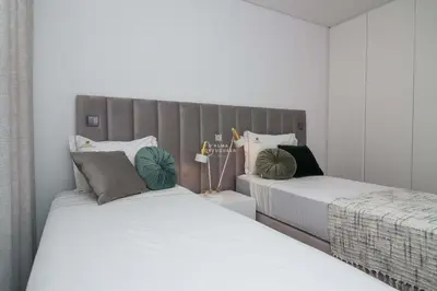 two beds sitting next to each other in a bedroom at Apartment Terracos do Mar - By Dalma Portuguesa in Quarteira