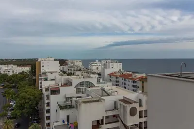 a view of a city with buildings and the ocean at Apartment Terracos do Mar - By Dalma Portuguesa in Quarteira