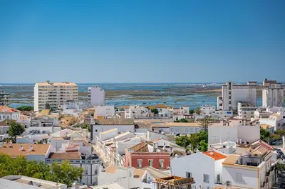 a view of a city with buildings and the ocean at My Place @ Faro Skyline in Faro