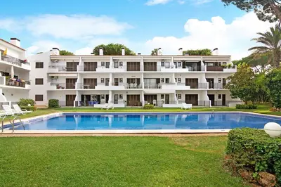 an apartment building with a swimming pool in front of it at Mouramar Vilamoura in Vilamoura