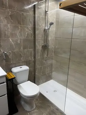 a bathroom with a toilet and a shower at Mouramar Vilamoura in Vilamoura