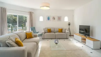 a living room with two couches and a tv at Casa SP- Villa with heated pool near Vilamoura, Vale do Lobo in Quarteira