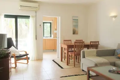 a living room with a couch and a table at Cosy flat, Salgados Village in Guia