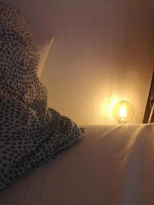 a bed with a pillow and a light on it at Loft Quinta da Balaia - Jacuzzi - By BEDZY in Albufeira