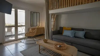 a living room with a couch and a table at Loft Quinta da Balaia - Jacuzzi - By BEDZY in Albufeira