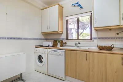 a bedroom with a bed and a table with a lamp at Jardins da Falésia Family Duplex in Albufeira
