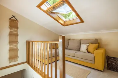 a bedroom with a bed and a nightstand with a lamp at Jardins da Falésia Family Duplex in Albufeira