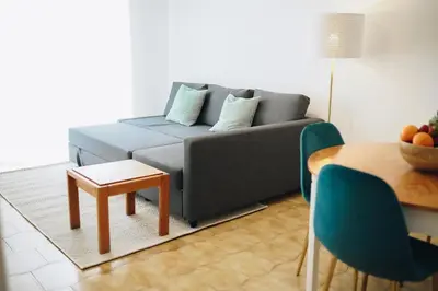 a living room with a couch and a table at Host Wise - Sweet & Sunny Flat - Ace Location in Quarteira