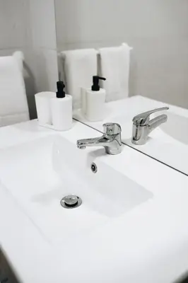 a bathroom with a sink and two toothbrushes at Host Wise - Sweet & Sunny Flat - Ace Location in Quarteira