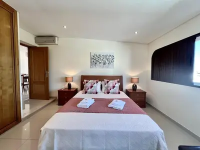 a bedroom with a bed with two towels on it at Quarteira Classic 1 With Pool by Homing in Quarteira