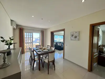 a kitchen and dining room with a table and chairs at Quarteira Classic 1 With Pool by Homing in Quarteira