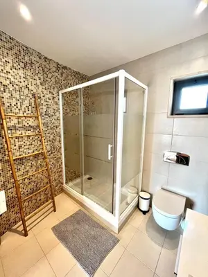 a bathroom with a glass shower and a toilet at Funtastic Villa With Pool in Albufeira