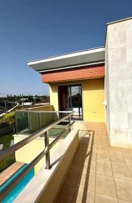 a house with a balcony and a swimming pool at Funtastic Villa With Pool in Albufeira