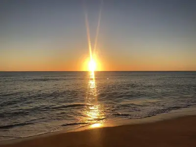 a sunset on the beach with the ocean at Quinta da Barracuda Prime Sea View Apartment in Albufeira